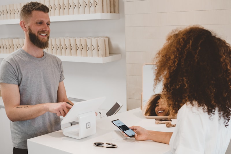 Friendly local business owner smiling with a tablet